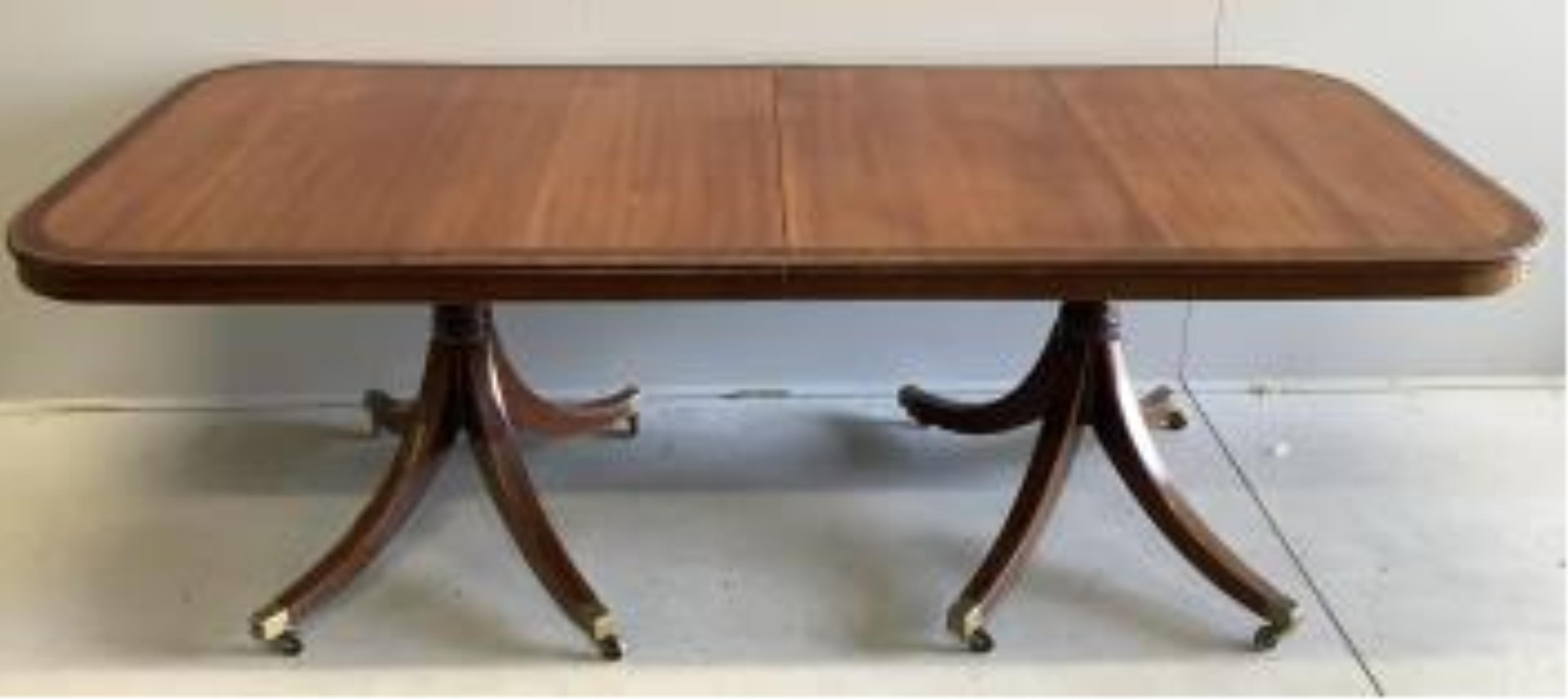 A reproduction mahogany twin pillar extending dining table, extended 300cm, two spare leaves, depth 91cm, height 72cm. Condition - good